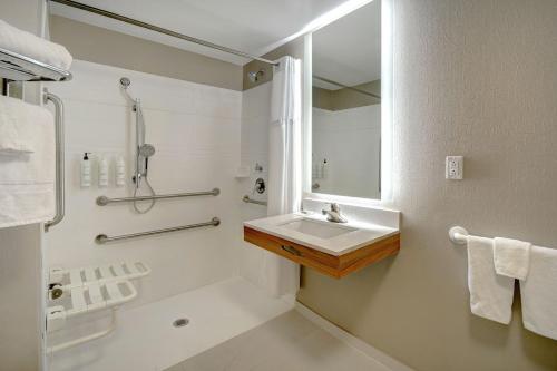 a bathroom with a sink and a shower at SpringHill Suites Erie in Erie
