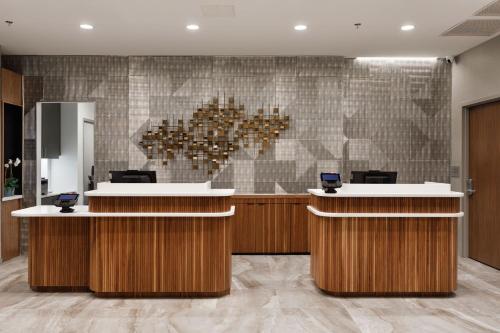 a lobby with a reception desk with a heart wall at Courtyard by Marriott Richmond Scott's Addition in Richmond