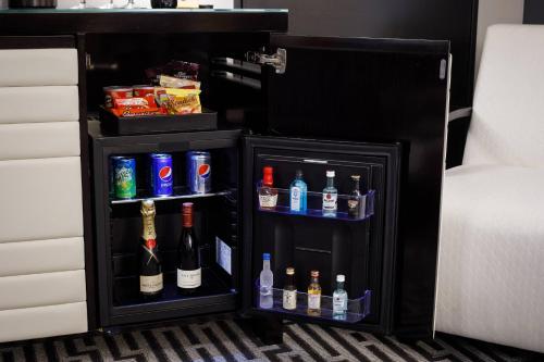 a small black refrigerator with bottles of alcohol in it at Hotel Metro, Autograph Collection in Milwaukee