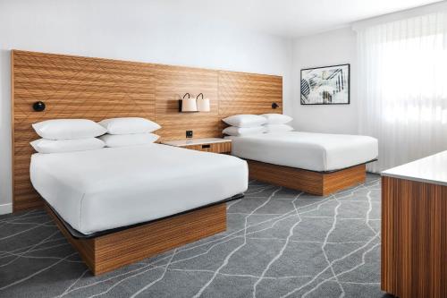 a hotel room with two beds and a counter at Delta Hotels by Marriott Grande Prairie Airport in Grande Prairie
