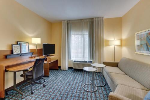 a hotel room with a couch and a desk at Fairfield Inn & Suites by Marriott Dunn I-95 in Dunn
