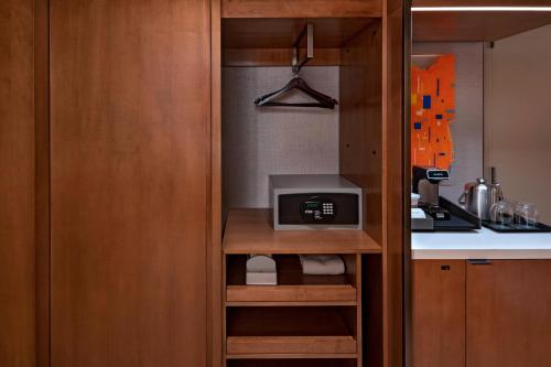 a small kitchen with a microwave and a counter at The Westin Irving Convention Center at Las Colinas in Irving
