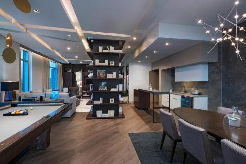 a kitchen and living room with a table and chairs at The Westin Irving Convention Center at Las Colinas in Irving