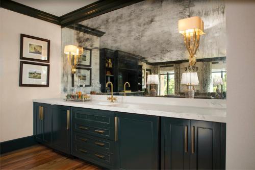 a bathroom with a sink and a mirror at Courtyard by Marriott Thomasville Downtown in Thomasville