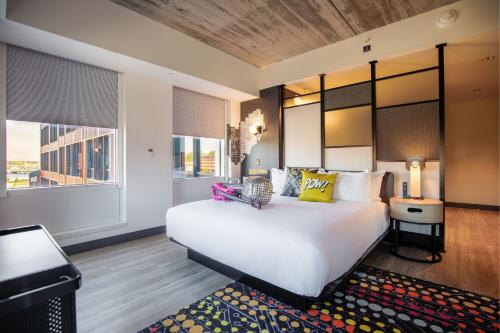 a bedroom with a large white bed and a large window at Aloft Providence Downtown in Providence
