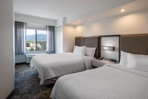 a hotel room with two beds and a window at SpringHill Suites by Marriott Colorado Springs South in Colorado Springs