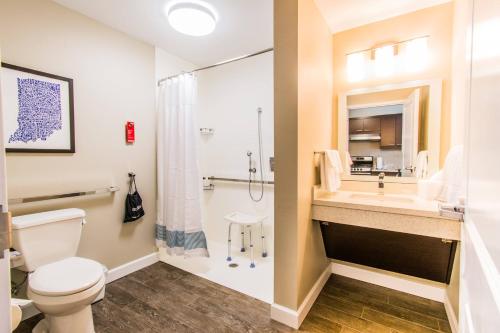 a bathroom with a toilet and a sink and a shower at TownePlace Suites by Marriott Evansville Newburgh in Newburgh