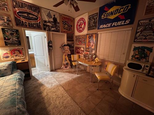 a room with a table and posters on the walls at My Oasis in Bakersfield