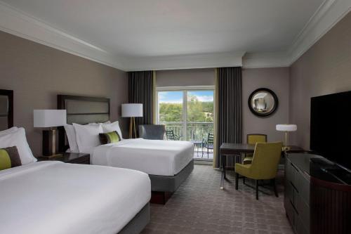a hotel room with two beds and a television at The Ballantyne, a Luxury Collection Hotel, Charlotte in Charlotte
