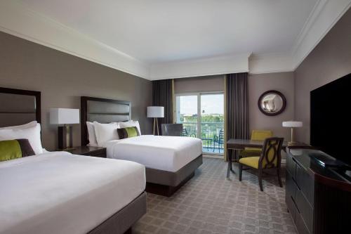 a hotel room with two beds and a television at The Ballantyne, a Luxury Collection Hotel, Charlotte in Charlotte