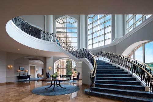 a spiral staircase in a building with a lobby at The Ballantyne, a Luxury Collection Hotel, Charlotte in Charlotte