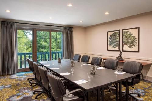 a conference room with a large table and chairs at The Ballantyne, a Luxury Collection Hotel, Charlotte in Charlotte