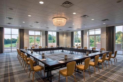 a large conference room with a long table and chairs at The Ballantyne, a Luxury Collection Hotel, Charlotte in Charlotte