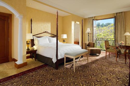 a hotel room with a bed and a balcony at Sheraton Addis, a Luxury Collection Hotel, Addis Ababa in Addis Ababa