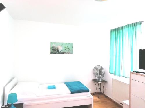 a small bedroom with a bed and a television at Favoriten-Rooms in Vienna