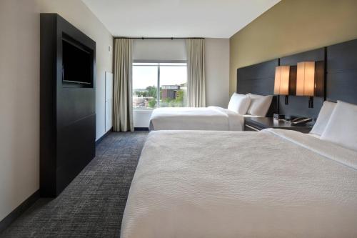 um quarto de hotel com duas camas e uma televisão de ecrã plano em Residence Inn Middletown Goshen em Middletown