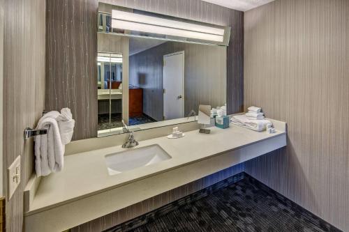 a bathroom with a sink and a mirror at Courtyard by Marriott Springfield in Springfield