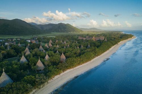 an aerial view of a beach next to the ocean at Sheraton New Caledonia Deva Spa & Golf Resort in Bourail