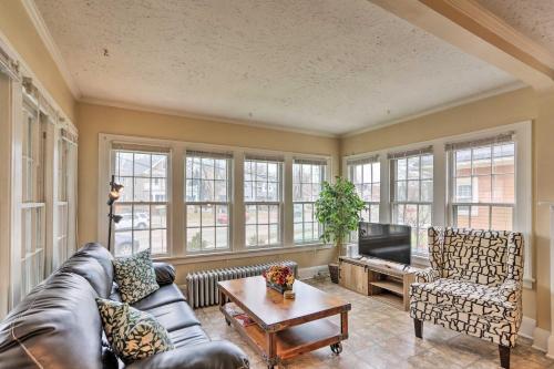 a living room with a couch and a tv and windows at Lakewood Home with Yard about 8 Mi to Cleveland! in Lakewood