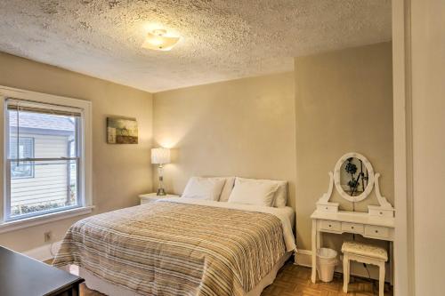 a bedroom with a bed and a mirror and a window at Lakewood Home with Yard about 8 Mi to Cleveland! in Lakewood