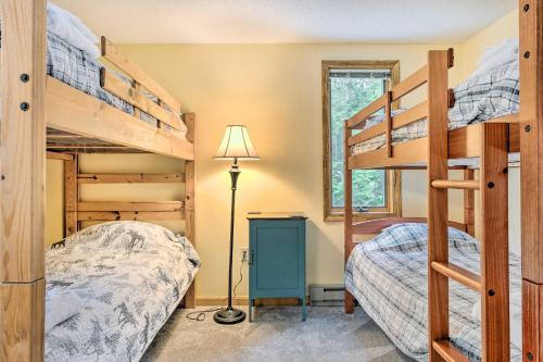 a bedroom with two bunk beds and a lamp at Campton Home with Mountain Views Near Trails and Lake in Campton