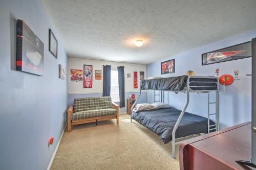 a bedroom with a bunk bed and a chair at Family Home with Yard about 15 Mi to Downtown! in Mooresville