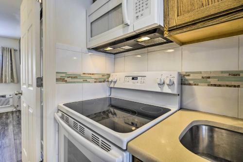 a small kitchen with a sink and a stove at Brigantine Vacation Rental - Walk to Beach! in Brigantine