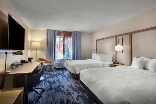 a hotel room with two beds and a desk at Fairfield Inn & Suites Elizabeth City in Elizabeth City