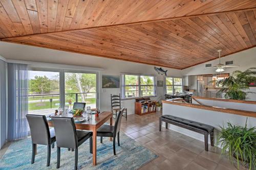 a dining room and living room with a wooden ceiling at Everglades Getaway with Deck and Water Views! in Everglades City