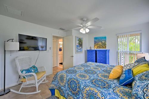 a bedroom with a bed and a ceiling fan at Everglades Getaway with Deck and Water Views! in Everglades City