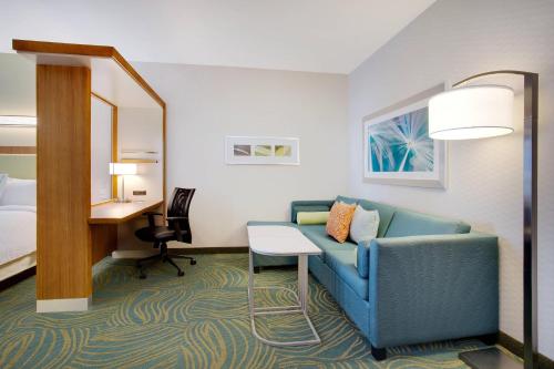a hotel room with a couch and a bed and a desk at SpringHill Suites by Marriott Murray in Murray