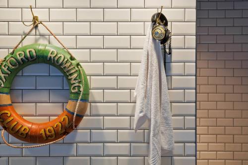 a horseshoe and a towel hanging on a wall at Moxy Amsterdam Houthavens in Amsterdam