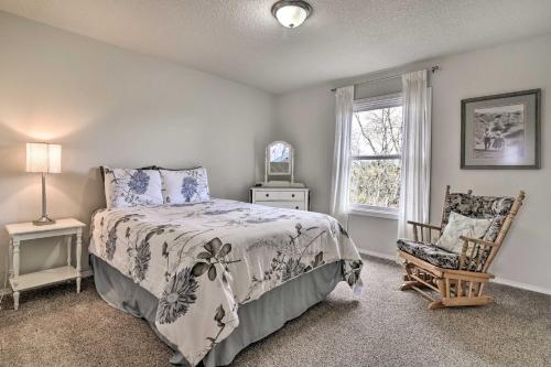 a bedroom with a bed and a chair and a window at Portland Area Home, 32 Mi to Mt Hood! in Damascus