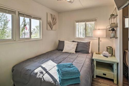 a bedroom with a bed and a table with a lamp at Cozy Lake Havasu City Getaway with Lake Views! in Lake Havasu City
