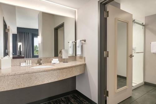 a bathroom with a sink and a mirror at Courtyard Lancaster in Lancaster