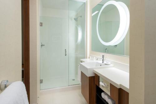 a bathroom with a sink and a shower with a mirror at SpringHill Suites by Marriott Los Angeles Burbank/Downtown in Burbank