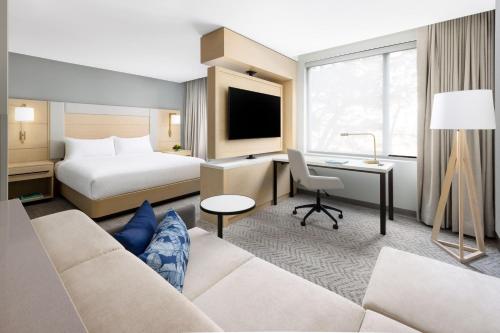 a hotel room with a couch and a bed and a desk at Residence Inn by Marriott San Juan Isla Verde in San Juan