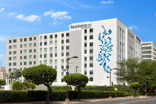 a white building with a blue sign on it at Residence Inn by Marriott San Juan Isla Verde in San Juan