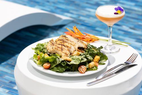 a plate of food with a salad and a drink at Residence Inn by Marriott San Juan Isla Verde in San Juan