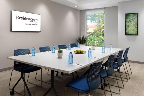 a conference room with a white table and blue chairs at Residence Inn by Marriott San Juan Isla Verde in San Juan