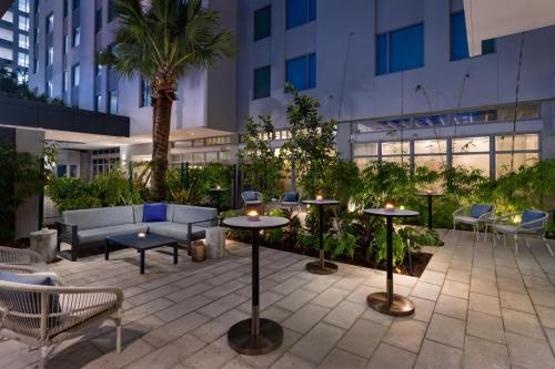 a patio with tables and chairs in a building at Residence Inn by Marriott San Juan Isla Verde in San Juan