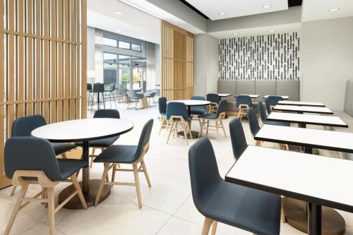 a dining room with tables and chairs at Residence Inn by Marriott San Juan Isla Verde in San Juan