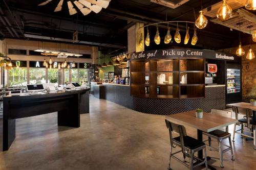 a restaurant with tables and chairs and a bar at Residence Inn by Marriott San Juan Isla Verde in San Juan
