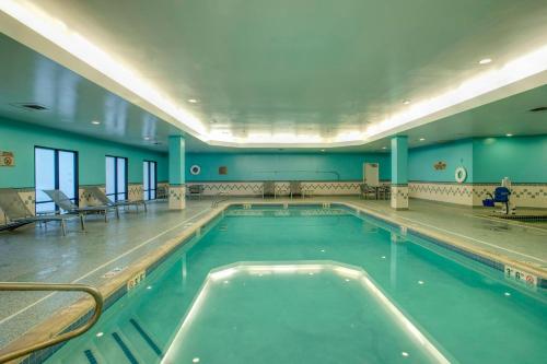 a large swimming pool in a building at SpringHill Suites by Marriott Lawrence Downtown in Lawrence