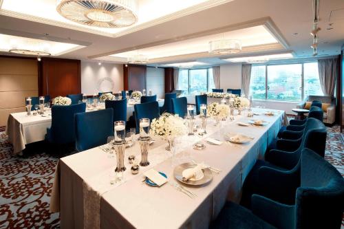a conference room with long tables and blue chairs at The Westin Tokyo in Tokyo