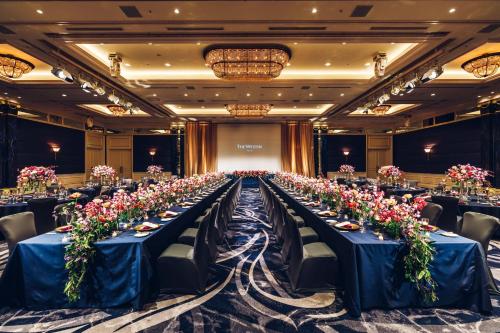 a long table in a banquet hall with blue tables at The Westin Tokyo in Tokyo
