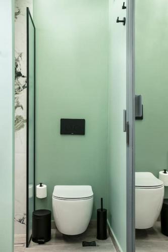 a bathroom with two toilets and a mirror at Athens Luxury Rooms I in Athens