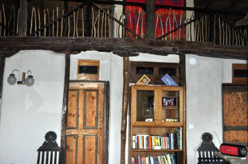 a room with two wooden doors and books at Maison adorée in Nea Vrasna