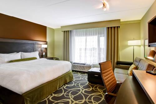 a hotel room with a bed and a desk at TownePlace Suites by Marriott Kincardine in Kincardine
