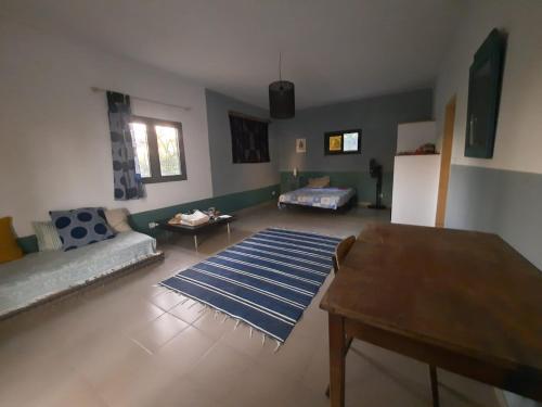 a living room with a couch and a table at Villa Soforal in Cap Skirring
